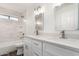 Updated bathroom with double vanity, quartz countertops, and a large mirror at 16442 N 59Th Pl, Scottsdale, AZ 85254