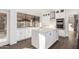 Modern kitchen featuring white cabinets, a large island, and stainless steel appliances at 16442 N 59Th Pl, Scottsdale, AZ 85254