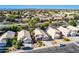 An aerial view shows a community with desert landscaping, mature trees, and well-kept lawns at 1778 S Saddle St, Gilbert, AZ 85233