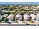 An aerial view features a desert neighborhood with desert landscaping and mature trees at 1778 S Saddle St, Gilbert, AZ 85233