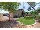 The backyard has a lawn, mature trees and bushes at 1778 S Saddle St, Gilbert, AZ 85233