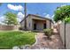 Well maintained backyard featuring lush lawn, desert landscaping, and a covered patio at 1778 S Saddle St, Gilbert, AZ 85233
