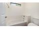 Bright bathroom featuring a bathtub with tile surround and a toilet at 1778 S Saddle St, Gilbert, AZ 85233