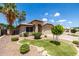 Attractive home with desert landscaping, complemented by lush green turf and mature trees at 1778 S Saddle St, Gilbert, AZ 85233