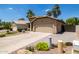 Cozy home with a private driveway, complemented by desert landscaping and mature trees at 1778 S Saddle St, Gilbert, AZ 85233