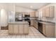 Well-lit kitchen featuring stainless steel appliances, tile flooring and countertops, and a center island at 1778 S Saddle St, Gilbert, AZ 85233