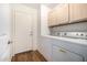 This laundry room features a washer, dryer, wood-look flooring and built in cabinets for storage at 1778 S Saddle St, Gilbert, AZ 85233