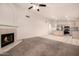 Open floor plan showcasing living room with fireplace flowing into eat-in kitchen with white appliances at 1778 S Saddle St, Gilbert, AZ 85233