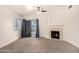 Bright living room featuring vaulted ceiling, fireplace, carpet flooring and slider to backyard at 1778 S Saddle St, Gilbert, AZ 85233