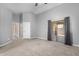 Large primary bedroom with neutral carpet, slider to balcony, and ensuite bath at 1778 S Saddle St, Gilbert, AZ 85233