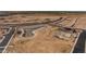 Aerial view of community amenities under construction, including a pond at 35907 W San Clemente Ave, Maricopa, AZ 85138