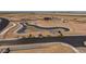 Aerial view of road and pond construction in a new community at 35907 W San Clemente Ave, Maricopa, AZ 85138