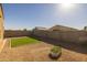 Landscaped backyard with artificial turf and planter at 35907 W San Clemente Ave, Maricopa, AZ 85138