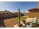 Artificial turf backyard with seating and umbrella at 35907 W San Clemente Ave, Maricopa, AZ 85138