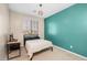 Bedroom with teal accent wall and a bed at 35907 W San Clemente Ave, Maricopa, AZ 85138