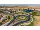 Aerial view of community with lake, park, and roundabout at 35907 W San Clemente Ave, Maricopa, AZ 85138