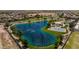 Community lake with walking paths, basketball court, and gazebo at 35907 W San Clemente Ave, Maricopa, AZ 85138