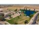 Aerial view of community amenities including a lake and school at 35907 W San Clemente Ave, Maricopa, AZ 85138