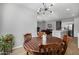 Round dining table with four chairs, located near the kitchen at 35907 W San Clemente Ave, Maricopa, AZ 85138