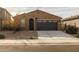 Single-story home with a two-car garage and desert landscaping at 35907 W San Clemente Ave, Maricopa, AZ 85138