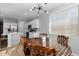 Bright kitchen with white cabinets, island, and dining area at 35907 W San Clemente Ave, Maricopa, AZ 85138