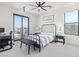 Bedroom with a striped comforter, private balcony, and ceiling fan at 3901 E Sagebrush St, Gilbert, AZ 85296