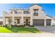 Two-story home with light stone exterior, balcony, and landscaped lawn at 3901 E Sagebrush St, Gilbert, AZ 85296