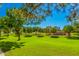 Landscaped green space with mature trees and a restroom facility at 3901 E Sagebrush St, Gilbert, AZ 85296