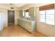 Light green cabinets and wood flooring in kitchen at 6908 E Windsor Ave, Scottsdale, AZ 85257