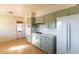 Kitchen with light green cabinets and view to living room at 6908 E Windsor Ave, Scottsdale, AZ 85257