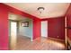 Open living room with hardwood floors and red painted walls at 6908 E Windsor Ave, Scottsdale, AZ 85257