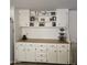 White cabinets and wooden countertop with storage above at 7300 N 51St Ave # E78, Glendale, AZ 85301