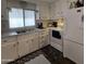 White cabinets and appliances, double sink, and laminate countertops in this galley kitchen at 7300 N 51St Ave # E78, Glendale, AZ 85301