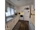 View of kitchen with white cabinets, laminate counters, and a stove at 7300 N 51St Ave # E78, Glendale, AZ 85301