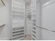 Walk-in closet with built-in shelving and drawers for optimal storage at 7955 E Chaparral Rd # 103, Scottsdale, AZ 85250