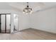 Dining area features wood-look tile floors and a modern chandelier at 7955 E Chaparral Rd # 103, Scottsdale, AZ 85250