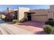 Charming single-story home featuring a two-car garage, stucco exterior, and well-maintained landscaping at 7955 E Chaparral Rd # 103, Scottsdale, AZ 85250