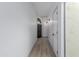 Bright hallway with wood-look tile flooring, contemporary lighting, and arched doorway at 7955 E Chaparral Rd # 103, Scottsdale, AZ 85250