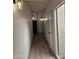 Bright hallway with wood-look flooring and modern light fixtures at 7955 E Chaparral Rd # 103, Scottsdale, AZ 85250