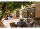 Charming patio with comfortable seating that provides shade, and has an exterior door leading into the home at 7955 E Chaparral Rd # 103, Scottsdale, AZ 85250