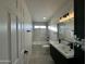 Modern bathroom with a double vanity, a soaking tub, and marble tile at 8050 E Tuckey Ln, Scottsdale, AZ 85250