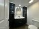 Modern bathroom with dark vanity and hexagon tile at 8050 E Tuckey Ln, Scottsdale, AZ 85250