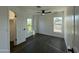 Bright bedroom with wood floors, a ceiling fan, and a window with natural light at 8050 E Tuckey Ln, Scottsdale, AZ 85250