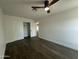 Bedroom with dark wood floors, a ceiling fan, and a double door closet at 8050 E Tuckey Ln, Scottsdale, AZ 85250