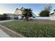 Two-story home with artificial turf lawn and palm trees at 8050 E Tuckey Ln, Scottsdale, AZ 85250