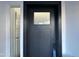 Close-up view of a modern black front door with glass panel at 8050 E Tuckey Ln, Scottsdale, AZ 85250