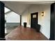 Covered entryway features a modern black door and tile flooring at 8050 E Tuckey Ln, Scottsdale, AZ 85250