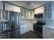 Modern kitchen with stainless steel appliances and white cabinetry at 8050 E Tuckey Ln, Scottsdale, AZ 85250