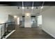 Open loft area with dark wood floors, metal railings and track lighting at 8050 E Tuckey Ln, Scottsdale, AZ 85250