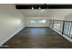 Spacious loft with wood flooring and a large window at 8050 E Tuckey Ln, Scottsdale, AZ 85250